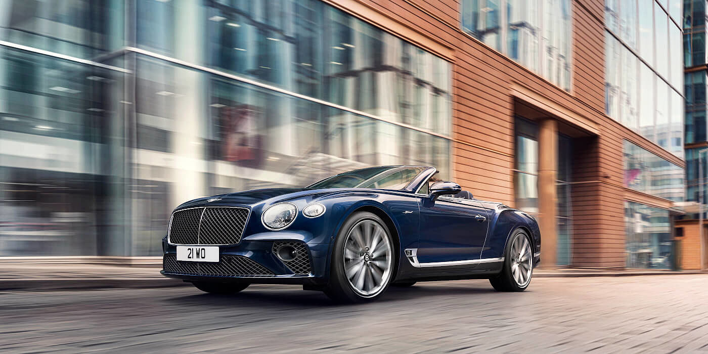 new-bentley-continental-gt-speed-convertible-in-peacock-blue-paint-driving-in-manchester