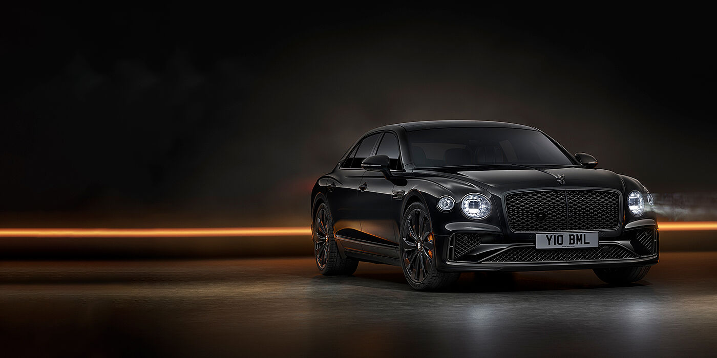 Bentley Hatfield Bentley Flying Spur Black Edition sedan in Black Crystal paint against a dark grey and copper coloured background