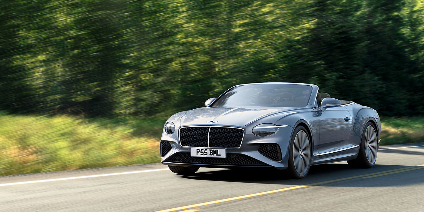 Bentley Hatfield New Bentley Continental GTC convertible front view in Silverlake paint with 22 inch ten spoke wheels, driving dynamically on a country road