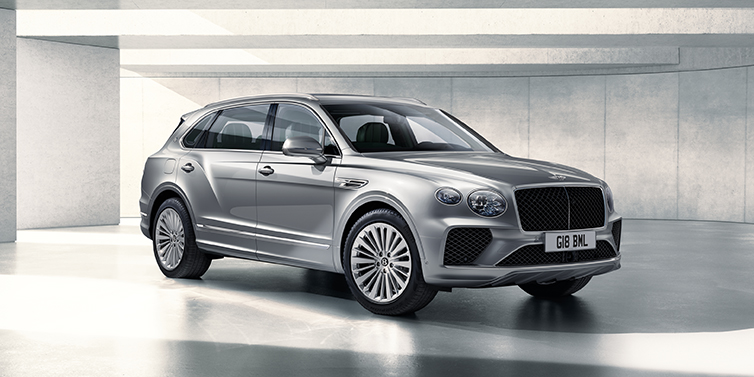 Bentley Hatfield Bentley Bentayga Extended Wheelbase SUV front three quarter in Moonbeam paint with a grey background