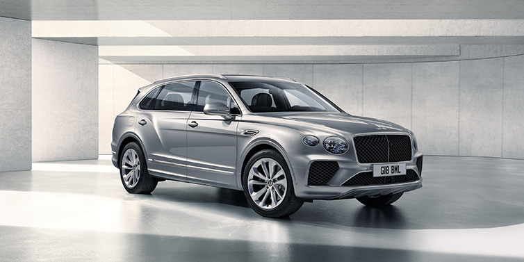 Bentley Hatfield Bentley Bentayga Extended Wheelbase SUV front three quarter in Moonbeam paint with a grey background