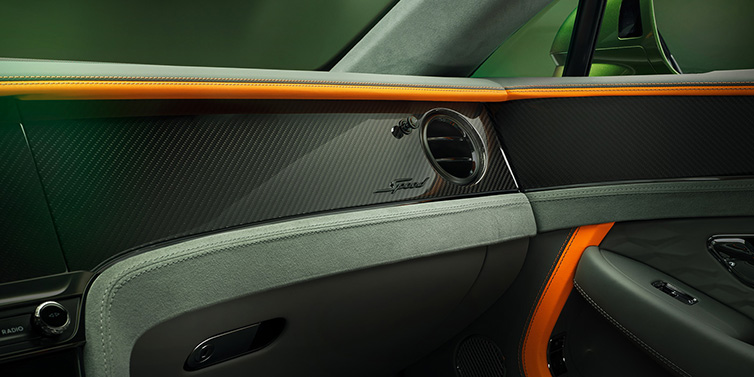 Bentley Hatfield Bentley Continental GT Speed coupe front interior dash detail with high gloss carbon fibre veneer surrounded by Mandarin by Mulliner and Gravity Grey hides