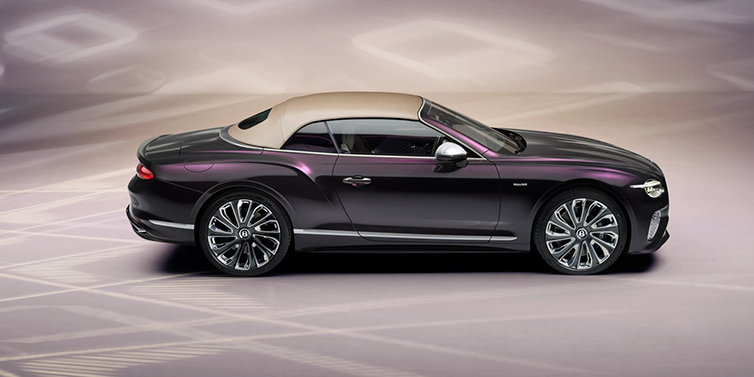 Bentley Hatfield Bentley Continental GTC Mulliner convertible in profile with hood up, in Tanzanite Purple paint and 22 inch Mulliner painted and polished wheels