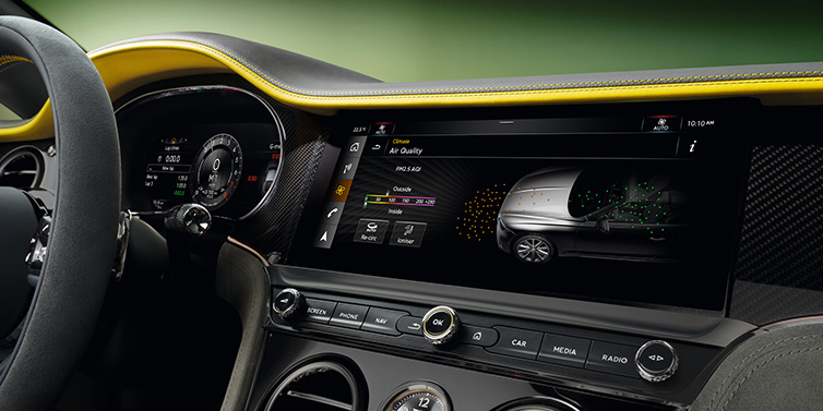 Bentley Hatfield Bentley Continental GTC Speed convertible front interior centre console with MMI screen showing Air Quality visualisation surrounded by Cyber Yellow by Mulliner and Gravity Grey hides and high gloss carbon fibre veneer