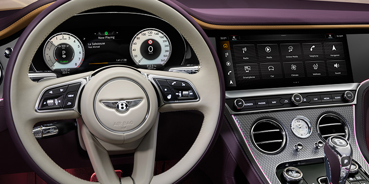 Bentley Hatfield Bentley Continental GTC Mulliner convertible steering wheel and drivers screens surrounded by Damson purple and Linen hides